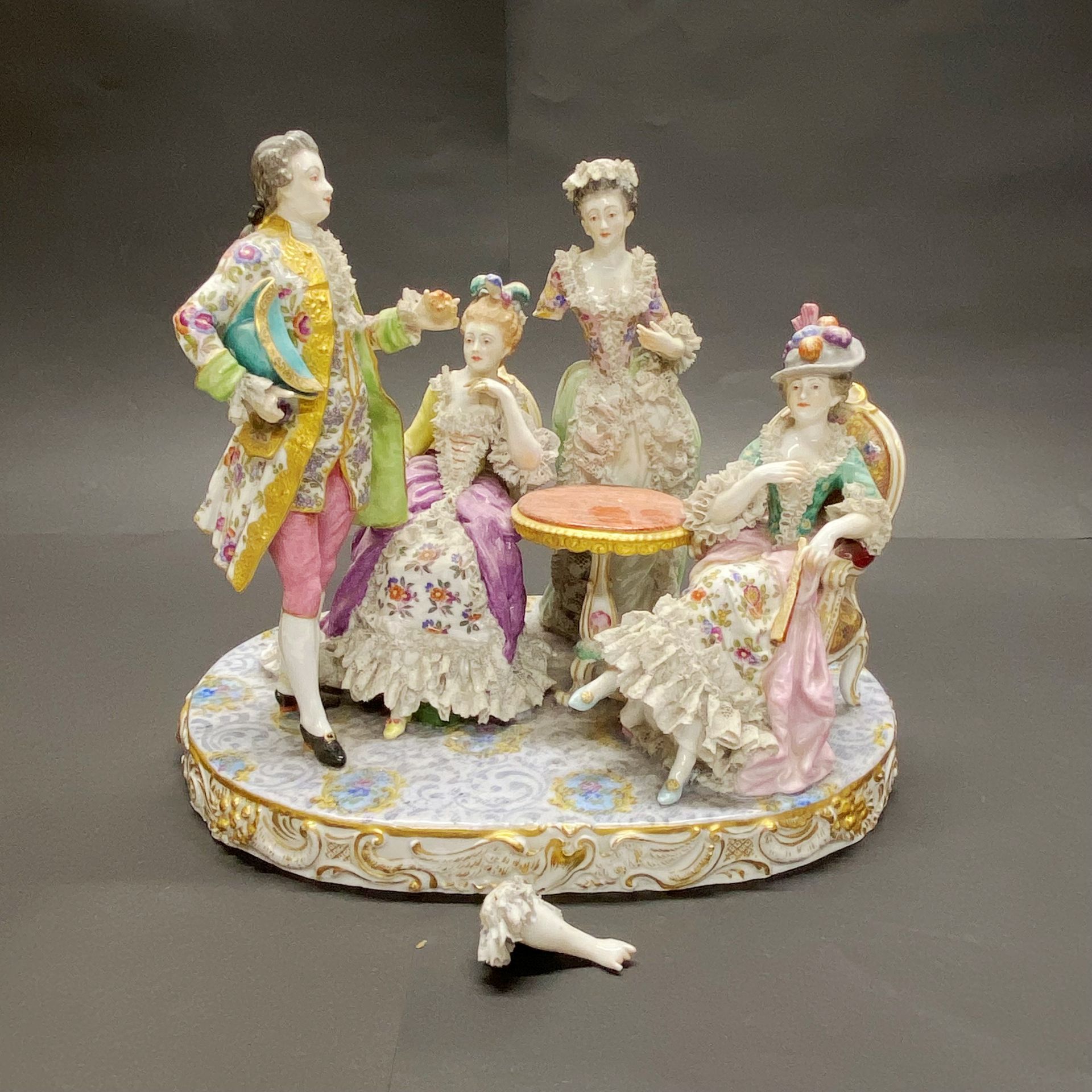 A 19thC German porcelain figure group. W. 29cm x H. 25cm (A/F)