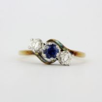 A hallmarked 18ct yellow gold ring set with a round cut sapphire and brilliant cut diamonds,