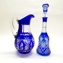 A large Bohemian glass jug and similar decanter, jug H. 33cm