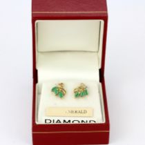 A boxed pair of 9ct yellow gold stud earrings set with marquise cut emeralds and diamonds, L. 1cm.