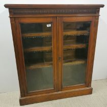 A carved mahogany glass fronted, four shelf bookcase, 107 x 92 x 31cm.