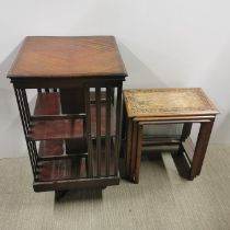 An inlaid mahogany revolving bookcase on castors, H. 84cm W. 48cm together with a carved oak and