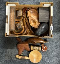 A box of mixed carved wooden items.