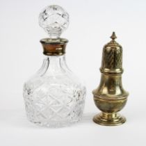 A hallmarked silver mounted cut crystal decanter with a hallmarked silver sugar shaker