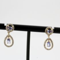 A pair of 10ct yellow gold tanzanite and diamond set drop earrings, L. 2cm.