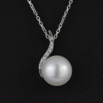 An 18ct white gold pendant set with a cultured pearl and diamonds on an 18ct white gold chain, L.