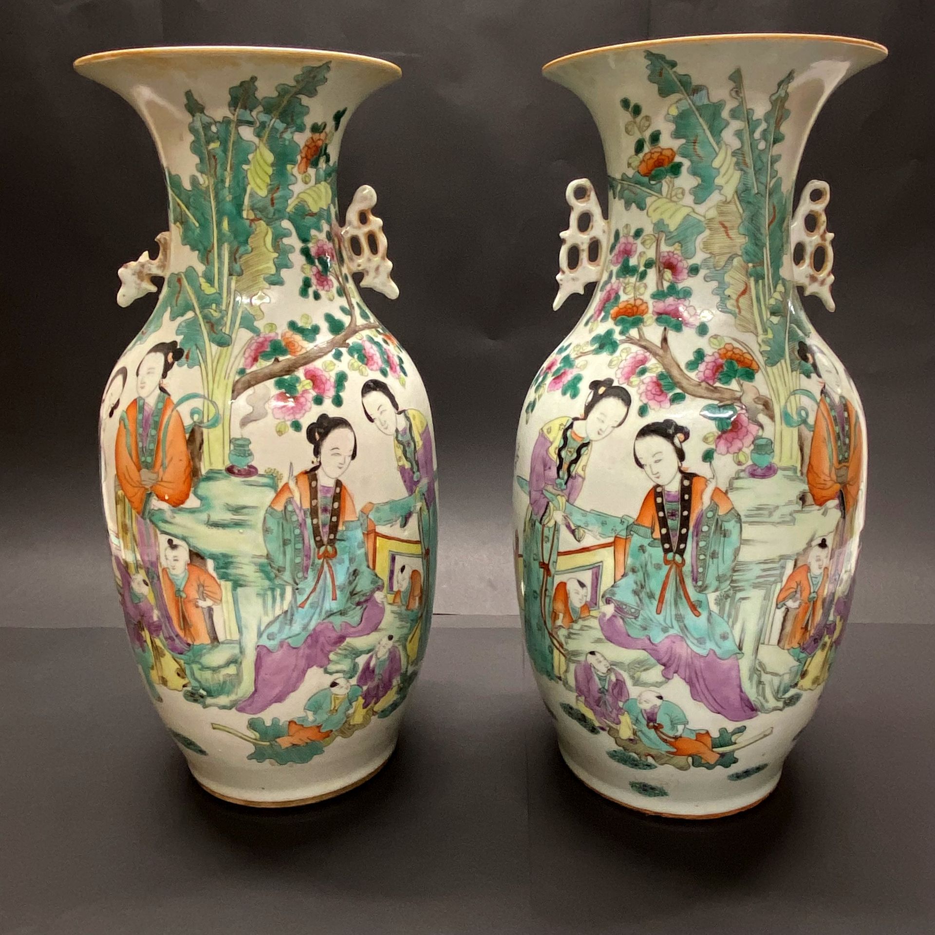 A pair of 19th/early 20thC Chinese hand painted porcelain vases. H. 43cm. (One repaired to rim)