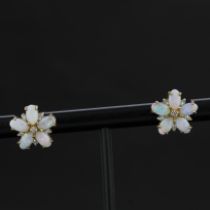 A pair of 9ct yellow gold flower shaped opal and diamond set stud earrings, L. 1.2cm.