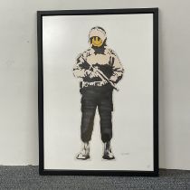 A Happy smiley grin soldier framed print by Banksy, left hand corner heavy weaponry embosted dry