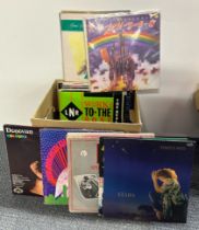 A box of mixed pop and rock LP records.