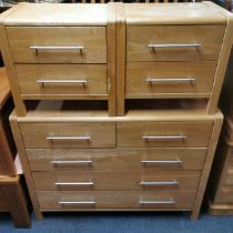 A modern light oak effect chest of drawers with metal handles, 110 x 86 x 46cm together with a