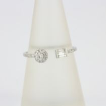 An 18ct white gold ring set with brilliant and baguette cut diamonds, (O)