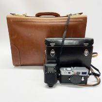 A Leica m9 camera with 3 different lenses and accessories and instruction manual in a high quality