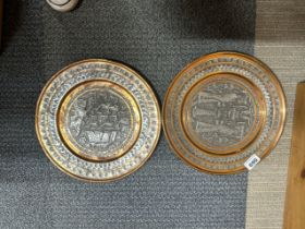 A pair of hammered and silvered copper Persian wall plates, Dia. 30cm.