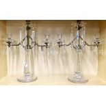 A pair of impressive silvered metal and crystal candelabras. H. 43cm