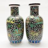 A pair of Chinese hand enamelled famille noir porcelain vases H. 40cm. Six character mark to base