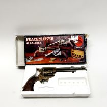 A vintage, full weight and size, wood and metal retrospective inert copy of a Western Peacemaker