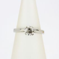 A white metal (tested minimum 9ct gold) solitaire ring set with a brilliant cut diamond, approx. 0.