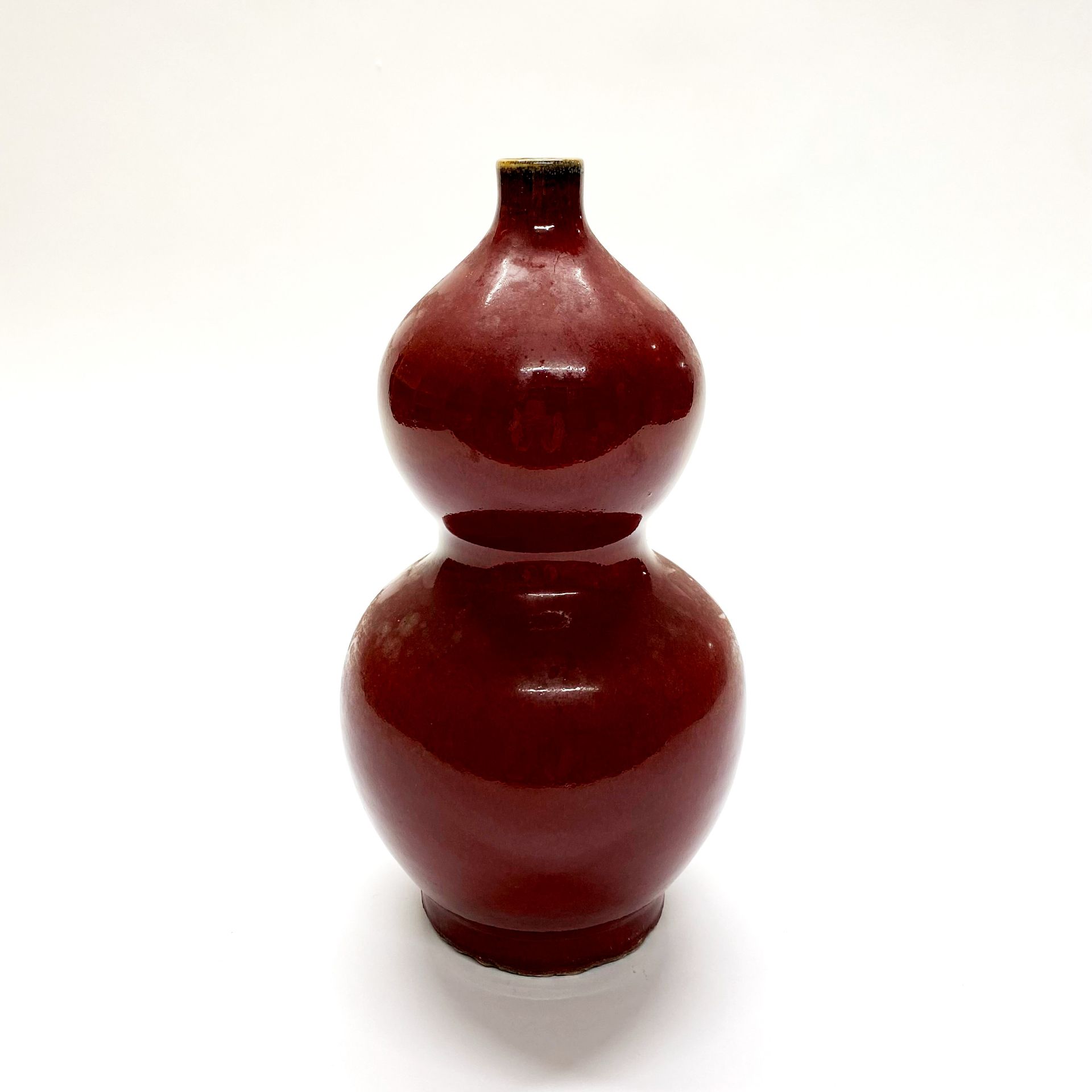 A Chinese sang de boeuf glazed porcelain gourd vase H. 25cm