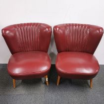 A pair of 1950's red vinyl cocktail chairs on turned wooden legs, H. 66cm.