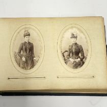 A Victorian leather bound album of photographs Size. 22cm x 15cm x 7cm.