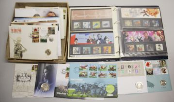 An album of Royal Mail millenium stamps, with a quantity of stamp and coin sets.