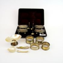 A cased set of hallmarked silver salts W. 6.5cm. With three spoons four silver napkin rings and a