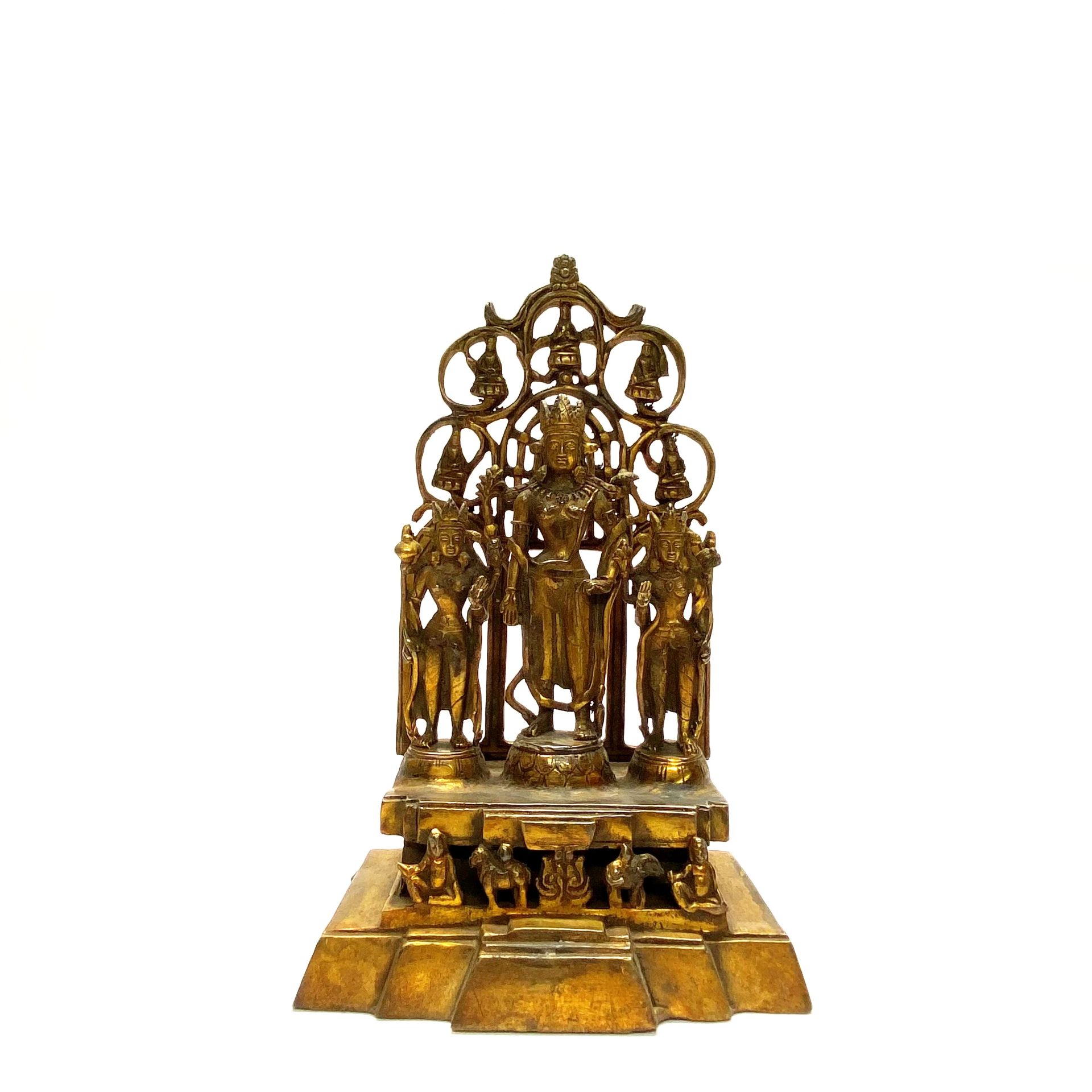 An interesting Tibetan gilt bronze temple figure of three standing deities H. 30cm