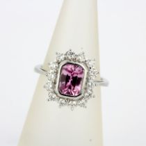An 18ct white gold ring set with pink sapphire, approx. 2ct, surrounded by brilliant cut diamonds,