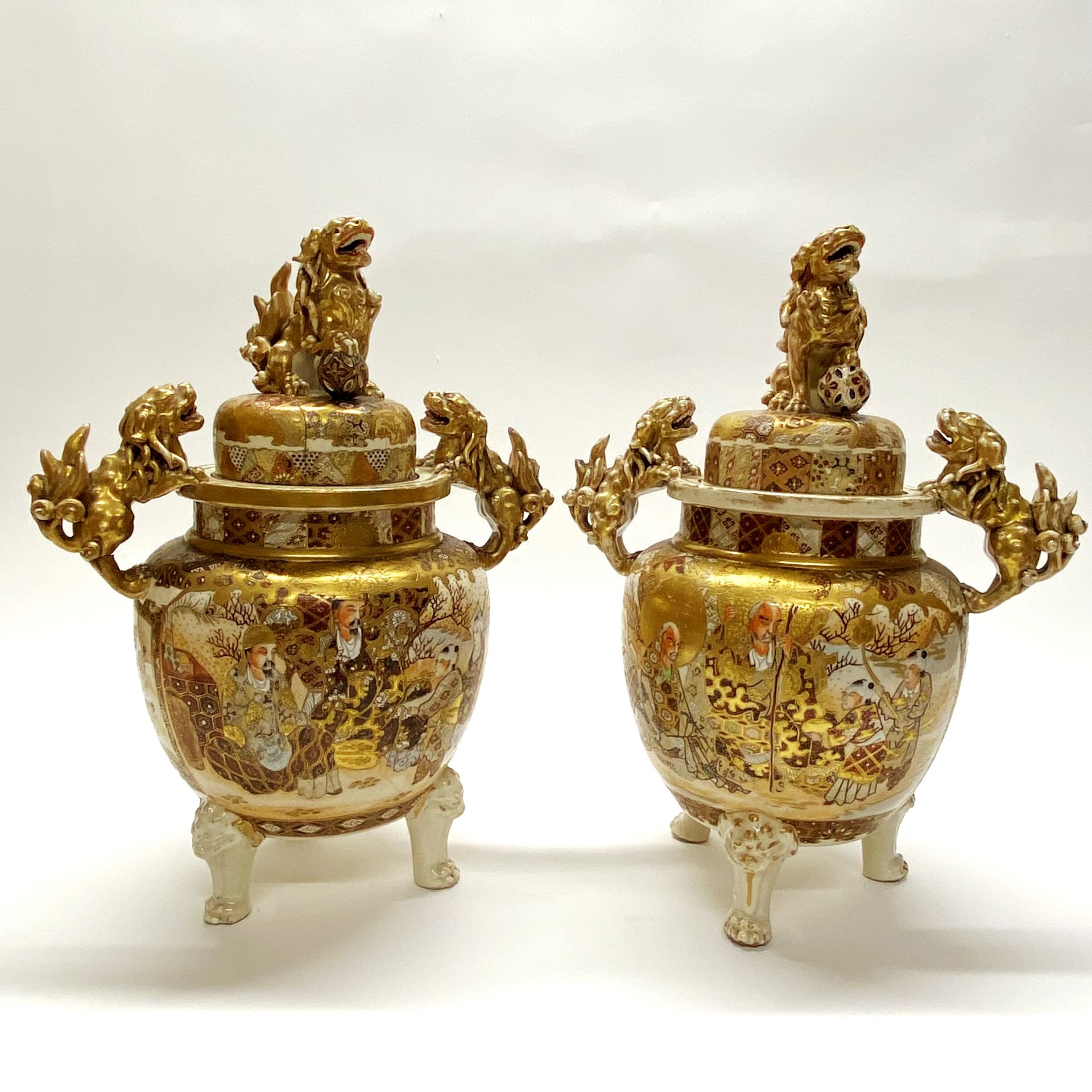A pair of 19thC Japanese gilt porcelain koros. H. 39cm (repair to one lid)