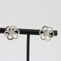 A pair of 18ct white gold flower shaped stud earrings set with brilliant cut diamonds, L. 1.6cm.