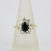 An 18ct yellow and white gold sapphire and diamond cluster ring, diamonds estimated approx. 0.70ct