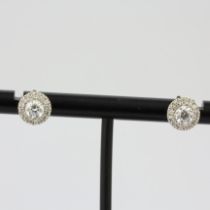 A pair of 18ct white gold halo stud earrings set with brilliant cut diamonds, approx. 1ct total,