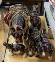 A very large ceramic shire horse, H. 45cm. Together with three others and a cart.