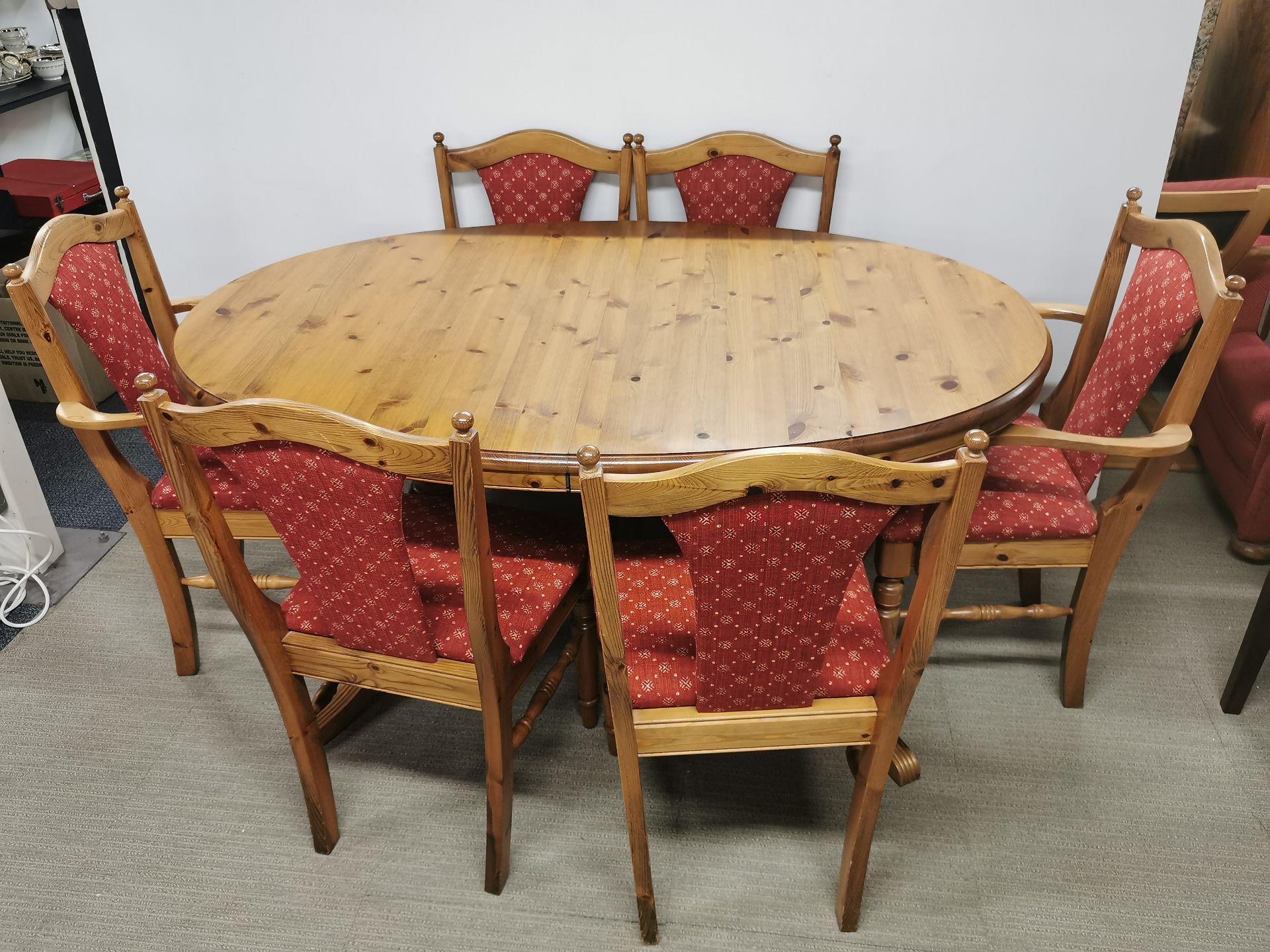 An extending pine oval dining table, L. 153cm, together with six dining chairs.