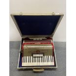 A cased Weltmeister piano accordion.