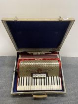 A cased Weltmeister piano accordion.