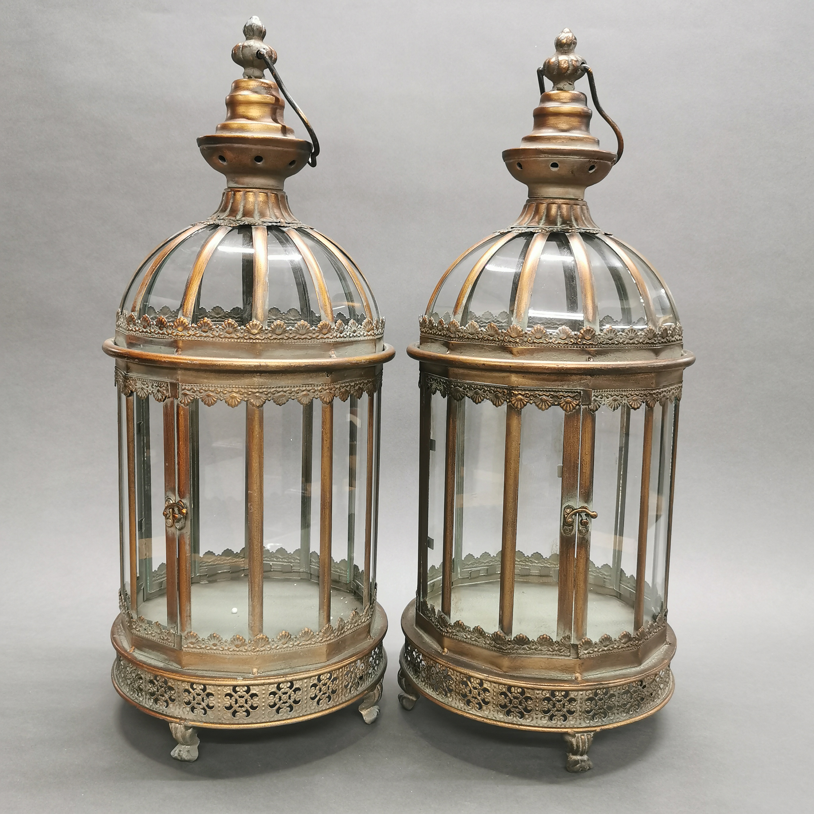 A pair of bronzed metal and glass garden lanterns, H. 62cm.