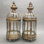 A pair of bronzed metal and glass garden lanterns, H. 62cm.