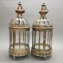 A pair of bronzed metal and glass garden lanterns, H. 62cm.