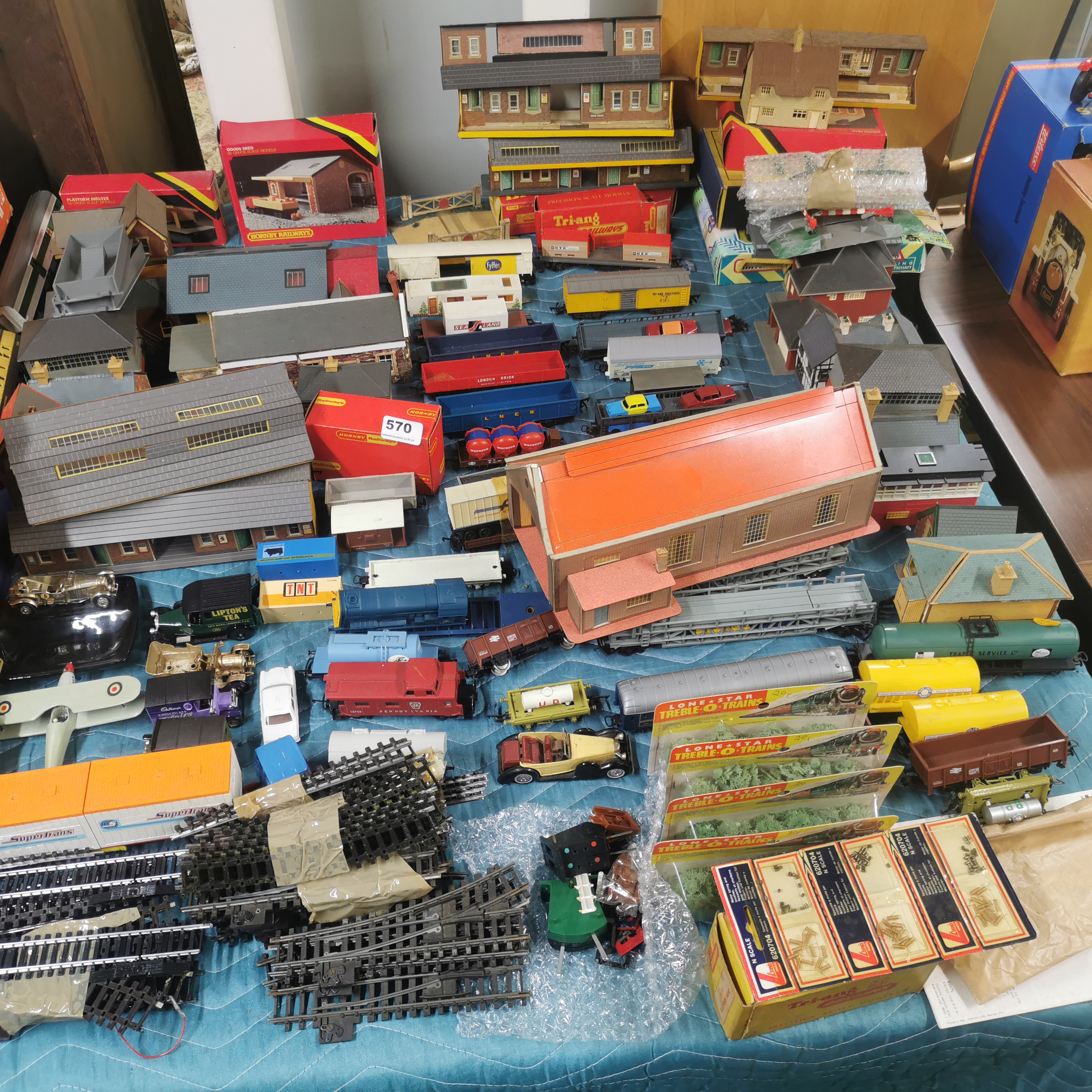 A large quantity of 00 gauge layout accessories and rolling stock.