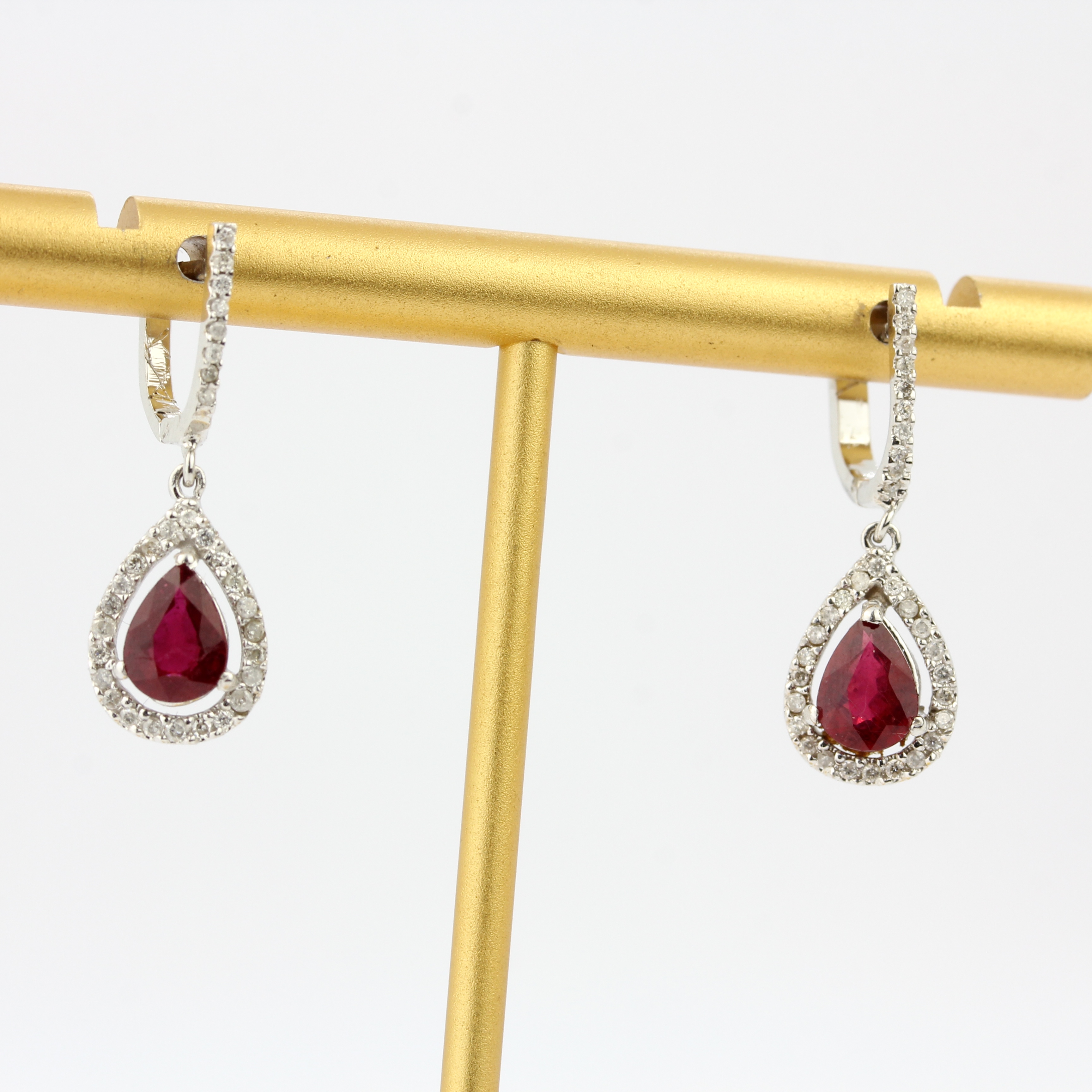 A pair of 18ct white gold drop earrings set with pear cut rubies and diamonds, L. 1.8cm. - Image 2 of 4
