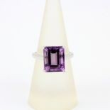 A 9ct white gold ring set with a large emerald cut amethyst, ring size N.5.