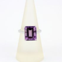 A 9ct white gold ring set with a large emerald cut amethyst, ring size N.5.