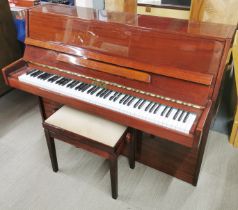 A Ritmuller upright piano.