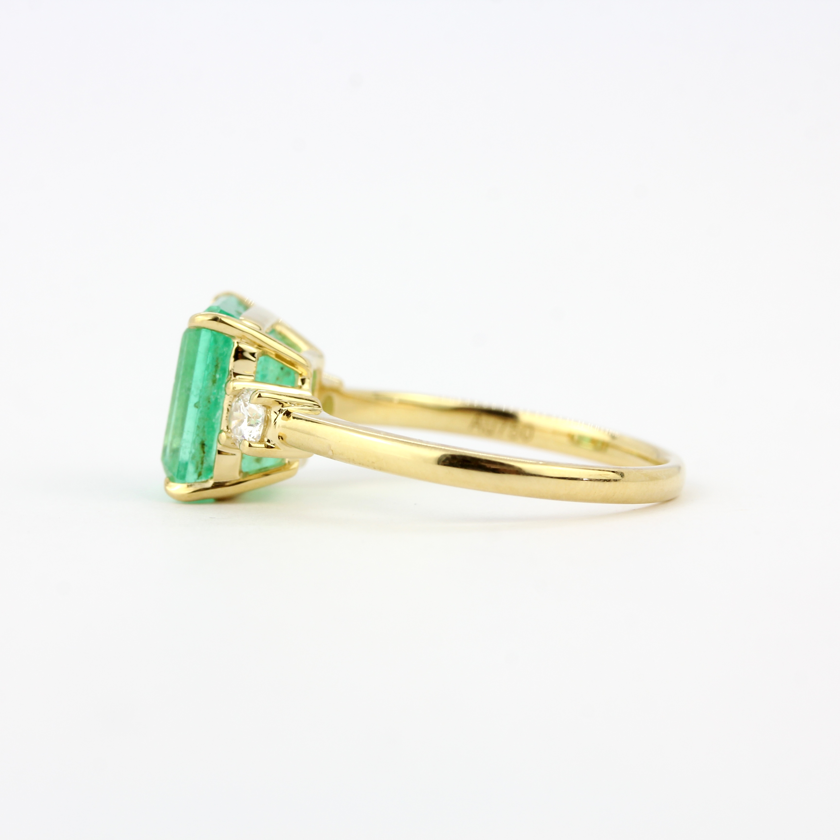 An 18ct yellow gold ring set with an emerald cut emerald flanked by diamonds, emerald 3.26ct, - Image 2 of 3