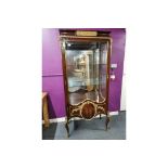 An early 20th century French ormolu mounted mahogany veneered display cabinet with glass shelves,