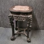 A Chinese marble topped carved hardwood table, H. 60cm.