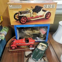 A boxed Mamod steam roller with a Wilesco model and two Burago cars.