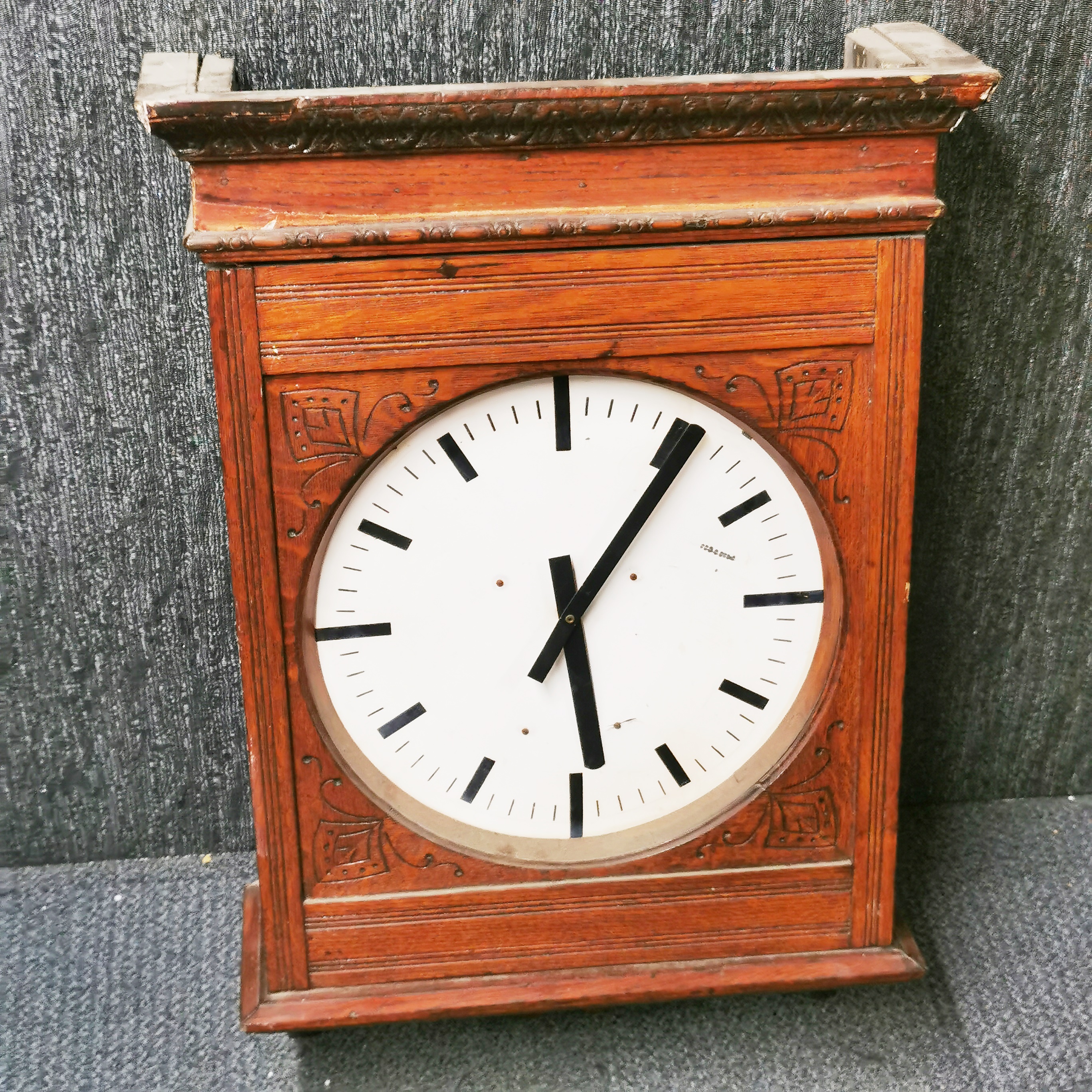 A large 19thC oak wall clock with battery replacement movement, 52 x 80cm.